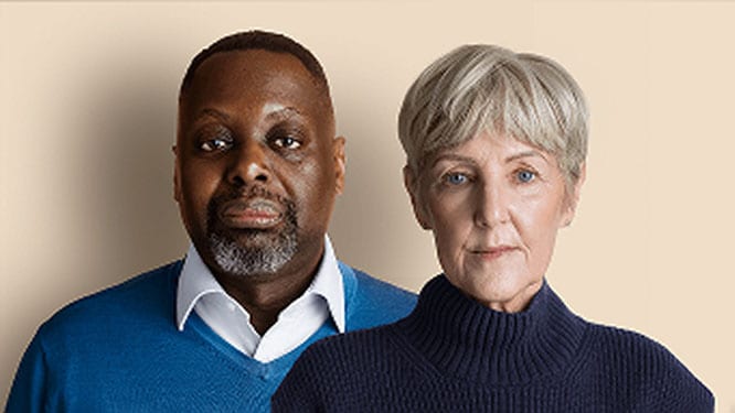 Two people in sweaters standing side by side
